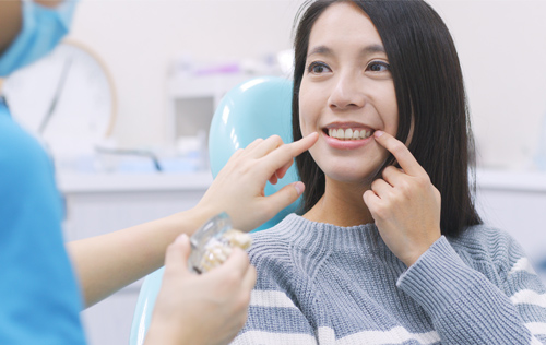 woman receives treatment from dental assistaint